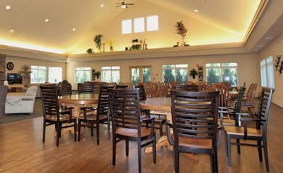 Bright communal area with wooden tables and chairs