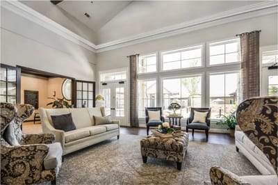 Comfortable common area with sofas and large windows