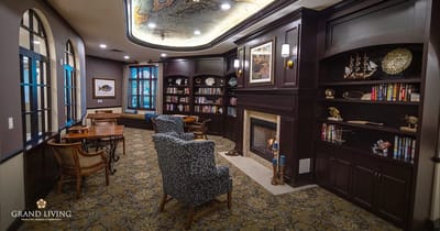 Interior common area with bookshelves and fireplace