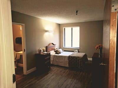 Cozy private resident room with bed and furniture