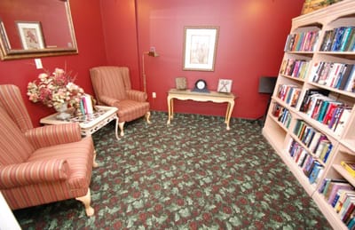 Cozy reading nook with bookshelves and armchairs