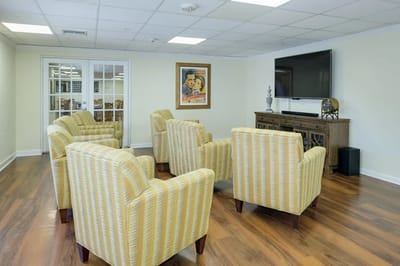 Interior common area with yellow chairs and TV