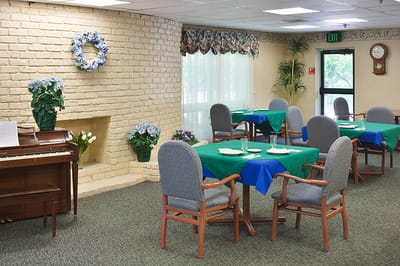 Dining area with blue tablecloths and piano