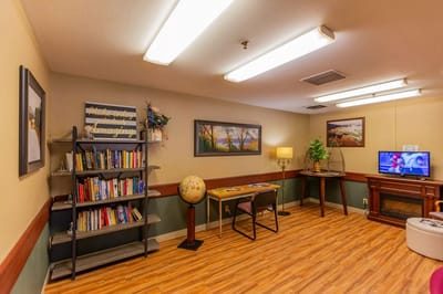Cozy common area with bookshelves and a TV