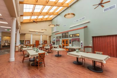 Dining area with tables set for residents