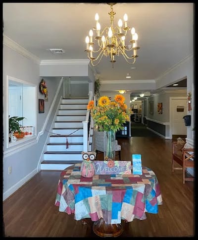 Bright lobby area with a welcome table and flowers