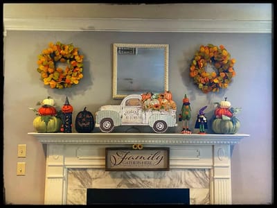 Decorative mantel with fall-themed decorations