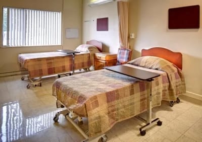 An interior view of a resident's room with beds