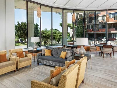 Bright lounge area with large windows and comfortable seating