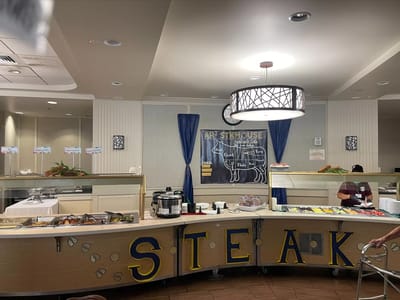 Dining area with food stations and staff serving