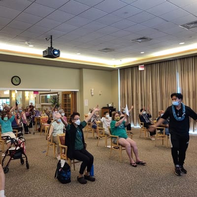 Residents and staff participating in an activity in a common area.