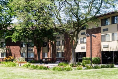 Exterior view of Hammond Elderly Apartments surrounded by trees