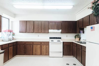 Interior kitchen area with wooden cabinets and appliances