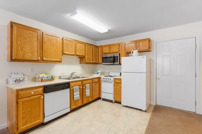 Bright kitchen area with wooden cabinets and modern appliances