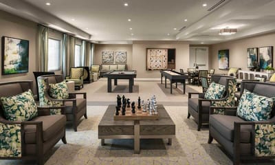 Bright activity room with seating and game tables