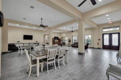 Bright common area with dining tables and seating
