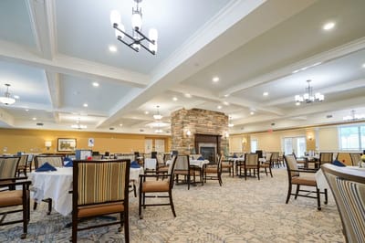 Dining room with tables and a stone fireplace