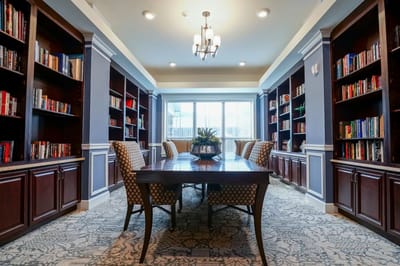 Interior view of a library with bookshelves and a table