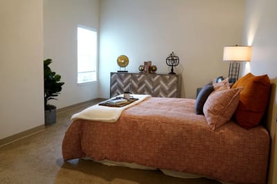 Cozy interior of a resident's bedroom with warm decor