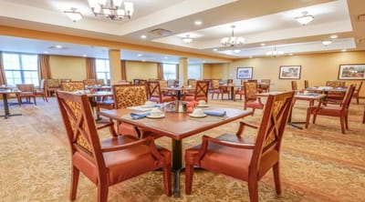 Bright dining room with tables set for meals