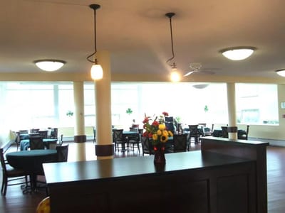 Bright dining area with tables and flowers