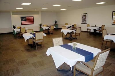 Dining room setup with tables and an American flag