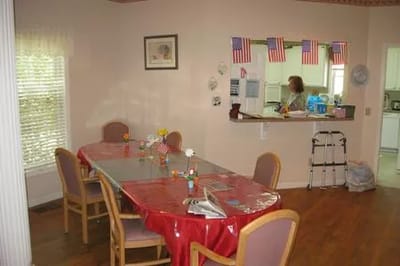 Dining area with tables and a resident present