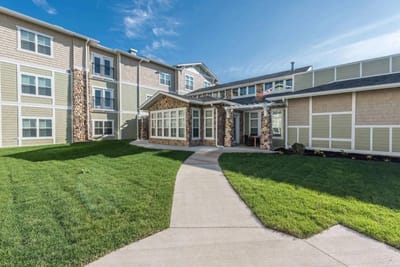 Exterior view of Heartis Village Peoria with landscaped pathway