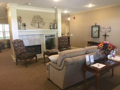 Cozy common area with seating and decorative fireplace