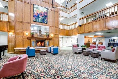 A cozy lobby area with seating and a fireplace