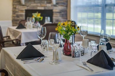 Elegant dining setup with flowers and glassware