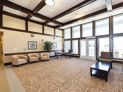 Bright common area with seating and large windows