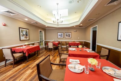 Dining area with red tablecloths and flowers