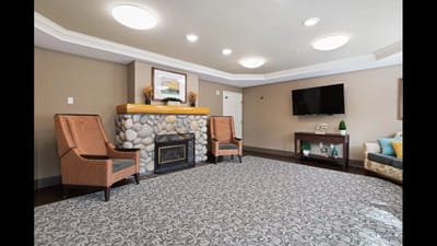 Cozy common area with chairs and a fireplace
