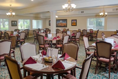 Bright dining room with tables set for meals