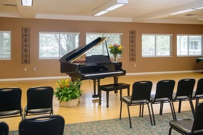 Interior space with a grand piano and seating