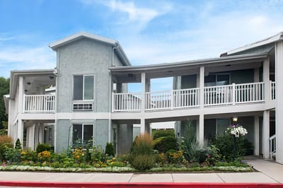 Exterior view of Highland Cove Retirement facility with landscaping