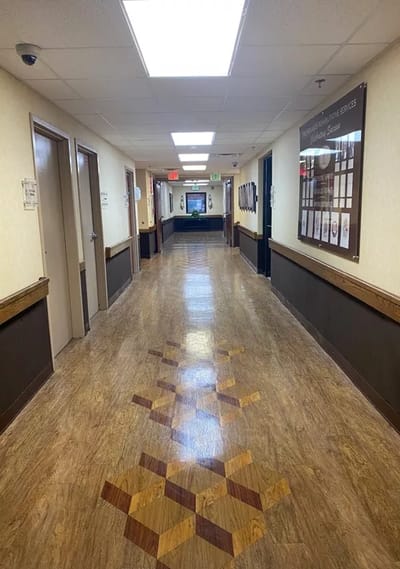 Interior hallway of a nursing home with wooden flooring