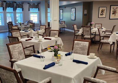 Dining room setup with tables and flowers
