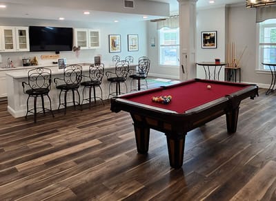 Common area with a pool table and bar seating