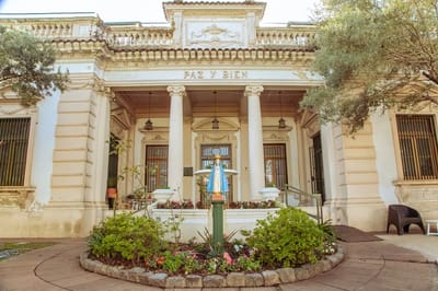 Exterior view of a senior living facility with garden