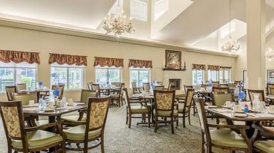 Dining room set up for a meal with chairs and tables