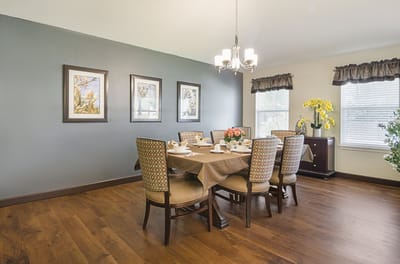 Dining room setup with a table and floral arrangements