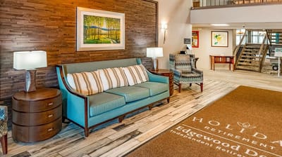 A cozy interior common area with seating and artwork