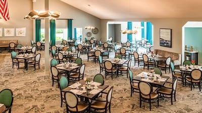 Bright dining area with tables set for residents