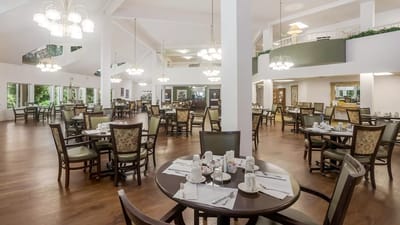 A spacious dining room with tables set for meals