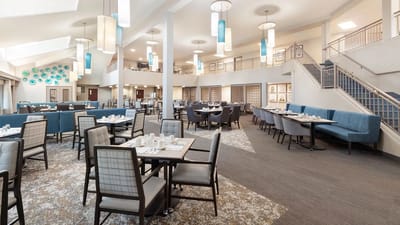 Spacious dining room with tables set for meals