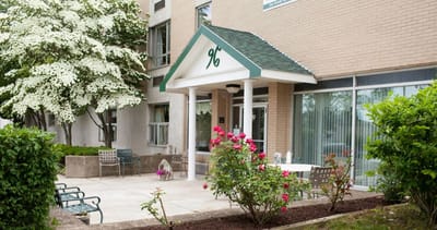 Entrance to the community with flowers and seating area