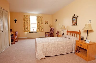 Bright private room with bed and seating area