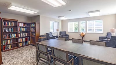 Common area with seating and a bookshelf